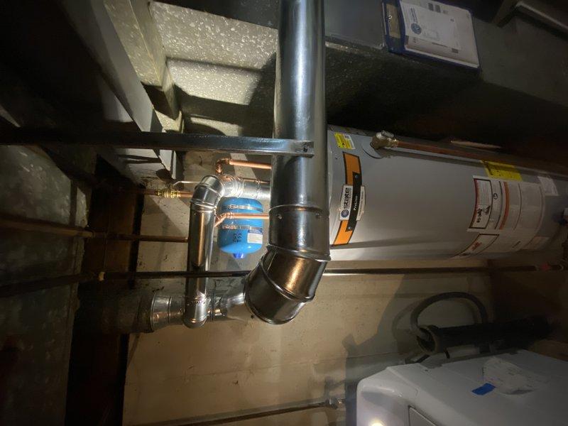 Completed installation of a 50-gallon tall gas water heater in residential basement utility room. Unit was set up in coordination with concurrent HVAC system installation and funded through Florissant Grant program. Installation included proper connection of copper supply and distribution piping, gas line hookup, and venting integration with existing ductwork. All plumbing connections were secured and tested for proper operation. City of Florissant permit was obtained for this installation, which did not require a separate plumbing inspection sticker per local code requirements.
