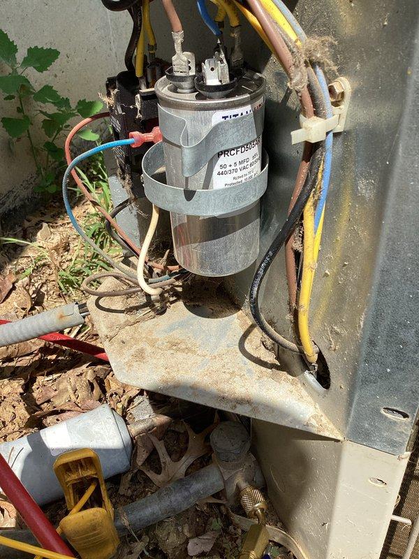 Responded to no cooling complaint on 12-year-old R-22 system. Upon arrival, performed diagnostic evaluation of outdoor unit, a Goodman PAT3NRO36-J 3-ton condensing unit operating on 208-230V single-phase power. Inspected dual-run capacitor rated at 50+5 MFD 370V, checked all electrical connections at compressor and condenser fan motor terminals, and verified unit nameplate specifications including 16.4 RLA compressor rating and 1/6 HP fan motor. Documented system conditions with photos of equipment data plate and capacitor wiring configuration for service records.
