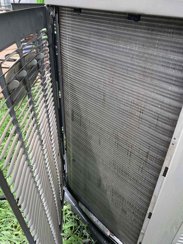 Responded to report of excessive water leakage from 10-year-old basement air handler unit with water migration to adjoining room causing carpet saturation and strong odor. Upon arrival, inspected indoor air handler and found active condensate drainage issue. Examined outdoor condenser unit coil, noting significant dirt and debris accumulation on fins requiring attention. Inspected air handler cabinet and confirmed Filtrete 1550 filter (16x25x4) in place with visible dust buildup on housing. Documented equipment condition with photos showing soiled condenser coils and filter assembly area. Identified condensate system malfunction as source of water leakage affecting basement flooring and adjacent carpeted area.
