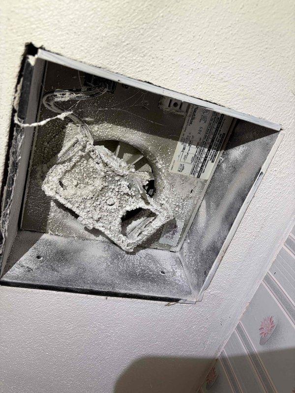 Responded to service call for non-operational bathroom exhaust fan on main floor. Upon inspection, found fan unit heavily clogged with significant dust and lint accumulation on blades, housing, and interior ductwork surfaces. Removed vent cover to access fan assembly and assessed mechanical components. The excessive debris buildup was preventing proper fan operation and restricting airflow through the ventilation system, creating a potential fire hazard and compromising bathroom ventilation efficiency.