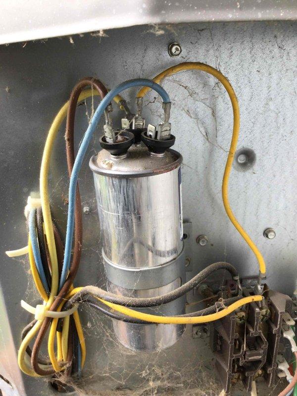 # HD#F60941403

Responded to no cooling complaint on 10+ year old air conditioning system. Upon arrival, confirmed condenser fan motor was not operating. Customer reported ability to manually spin fan blade, but noted excessive noise when doing so, indicating failing motor bearings.

Performed diagnostic evaluation of outdoor condensing unit. Testing revealed failed run capacitor preventing fan motor from starting. Capacitor showed no measurable capacitance and visible signs of deterioration. Additionally, condenser fan motor exhibited mechanical resistance and bearing failure, confirmed by manual rotation test and abnormal noise levels.

Replaced dual run capacitor with proper MFD-rated component to manufacturer specifications. Installed new condenser fan motor assembly with correct horsepower and RPM ratings for unit. Secured all electrical connections to capacitor terminals and motor leads, ensuring proper wire routing and strain relief.

Connected refrigerant manifold gauge set to 