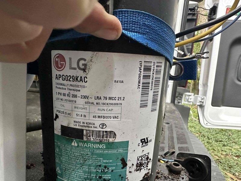 Replaced failed compressor under warranty on LG outdoor unit, model APG029KAC, serial number E174915992, restoring cooling operation. Accessed property during specified timeframe, installed new compressor, recharged refrigerant system with R410A, and verified proper operation with temperature and pressure readings. Retained defective compressor for warranty processing.