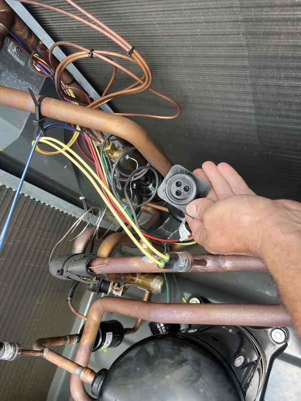 Responded to no cooling call on outdoor unit U10 located at side of home. Upon inspection, found system not operating due to failed pressure switch sensor. Removed defective pressure control component from compressor assembly, installed replacement sensor, verified proper electrical connections, and tested system operation. Unit restored to normal cooling function with all safety controls operating within manufacturer specifications.