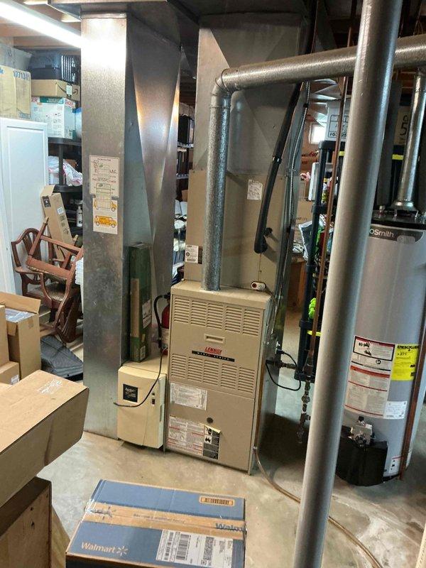 Responded to no cooling complaint on 16-year-old residential air conditioning system. Upon arrival, performed comprehensive diagnostic evaluation of both indoor Lennox furnace/air handler unit and outdoor condensing unit. System had received maintenance service in April but was failing to maintain desired indoor temperatures. Conducted visual inspection of equipment, checked refrigerant pressures, tested electrical components, and verified proper airflow through the system. Evaluated condenser operation, blower motor function, and thermostat communication. Documented equipment condition with photos of basement air handler installation and exterior condensing unit. Identified root cause of cooling deficiency and completed necessary repairs to restore system to proper operating condition. Tested system operation post-repair to confirm adequate cooling capacity and temperature differential across evaporator coil. Unit cycling properly and maintaining setpoint upon departure.
