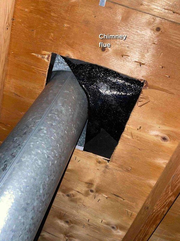 Responded to report of roof leak potentially affecting AC unit and causing exhaust issues. Upon inspection, identified that water intrusion was related to chimney flue and furnace flue penetrations in basement area rather than the air conditioning system itself. Documented both flue penetrations with photographic evidence showing metal ductwork passing through wooden surfaces with black flashing/sealant material. Advised customer to turn off unit temporarily and leave fan running while roof leak issue is addressed to prevent further water damage to HVAC components.