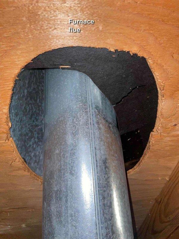 Responded to report of roof leak potentially affecting AC unit and causing exhaust issues. Upon inspection, identified that water intrusion was related to chimney flue and furnace flue penetrations in basement area rather than the air conditioning system itself. Documented both flue penetrations with photographic evidence showing metal ductwork passing through wooden surfaces with black flashing/sealant material. Advised customer to turn off unit temporarily and leave fan running while roof leak issue is addressed to prevent further water damage to HVAC components.