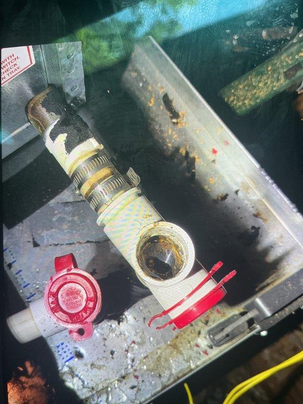 Responded to no-cool call on 17-year-old attic unit that was not turning on. Upon inspection, found humidifier solenoid valve had failed and was causing system lockout. Removed deteriorated humidifier valve assembly showing significant corrosion and mineral buildup on mounting surface and surrounding components. Noted extensive rust staining on cabinet base and biological growth throughout unit interior, consistent with age and attic installation environment. Replaced failed humidifier valve with new assembly, verified proper electrical connections, and restored system operation. Unit cooling normally upon departure.