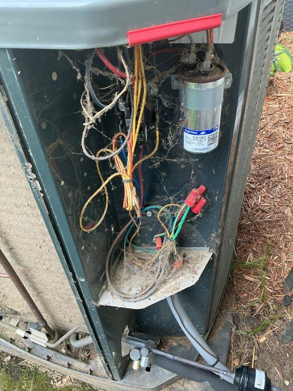 Responded to no cooling call on 2017 residential HVAC system affecting entire home. Upon arrival, performed diagnostic inspection of outdoor condensing unit. Removed access panel and inspected electrical components, wiring connections, and capacitor. Observed signs of normal wear and dirt accumulation consistent with system age. Examined refrigerant lines and heat exchange components on rear panel, noting deteriorated insulation and accumulated debris. Documented system condition with photographs for service records. Completed standard troubleshooting protocol to identify cause of cooling failure and restore comfort to residence.