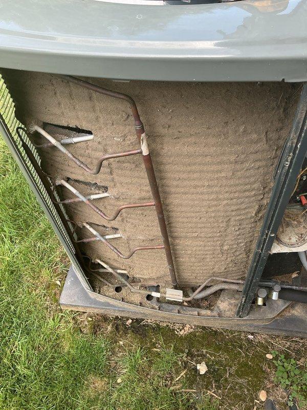 Responded to no cooling call on 2017 residential HVAC system affecting entire home. Upon arrival, performed diagnostic inspection of outdoor condensing unit. Removed access panel and inspected electrical components, wiring connections, and capacitor. Observed signs of normal wear and dirt accumulation consistent with system age. Examined refrigerant lines and heat exchange components on rear panel, noting deteriorated insulation and accumulated debris. Documented system condition with photographs for service records. Completed standard troubleshooting protocol to identify cause of cooling failure and restore comfort to residence.