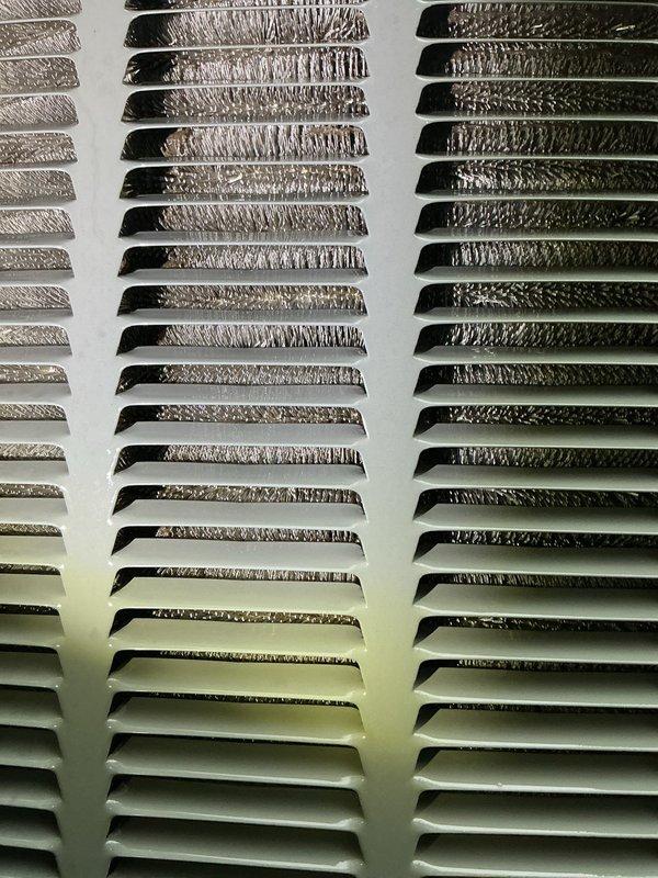 Responded to no cooling complaint with indoor temperature reading 80°F despite thermostat set to 72°F. Upon inspection, found 10+ year old outdoor condenser unit with severely restricted airflow due to heavy dust, dirt, and debris accumulation blocking louver fins and grilles. Performed thorough cleaning of condenser coils and ventilation louvers, removed plant debris and obstructions from unit exterior, and restored proper airflow to system. Unit tested successfully with normal cooling operation restored.