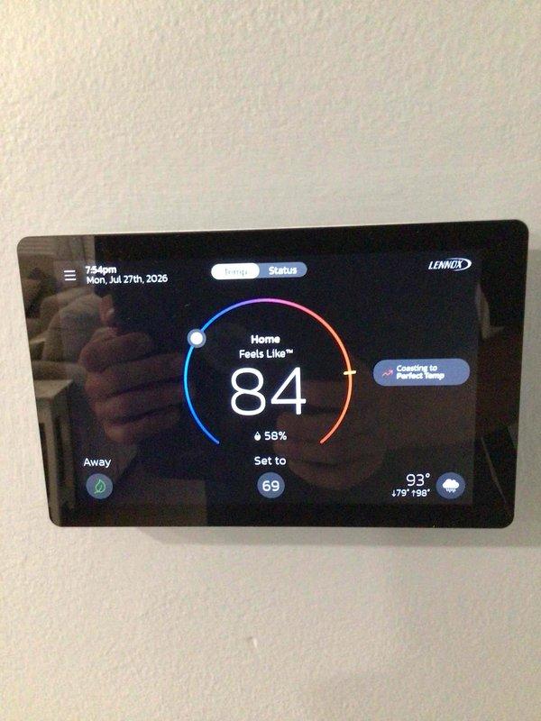 Responded to no cooling complaint on three-year-old Lennox system. Upon arrival, thermostat displayed 84°F indoor temperature with setpoint of 69°F and system actively calling for cooling. Outdoor condenser unit showed significant dirt accumulation and debris on coil fins with visible streaking and discoloration affecting heat transfer efficiency. Performed diagnostic evaluation and determined dirty condenser coil was restricting airflow and preventing proper heat rejection, causing reduced cooling capacity and extended run times.
