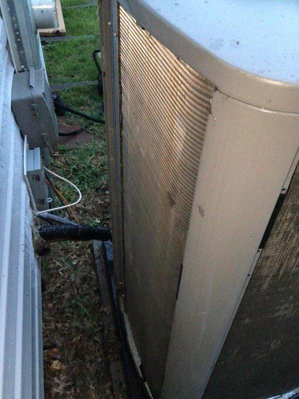 Responded to no cooling complaint on three-year-old Lennox system. Upon arrival, thermostat displayed 84°F indoor temperature with setpoint of 69°F and system actively calling for cooling. Outdoor condenser unit showed significant dirt accumulation and debris on coil fins with visible streaking and discoloration affecting heat transfer efficiency. Performed diagnostic evaluation and determined dirty condenser coil was restricting airflow and preventing proper heat rejection, causing reduced cooling capacity and extended run times.
