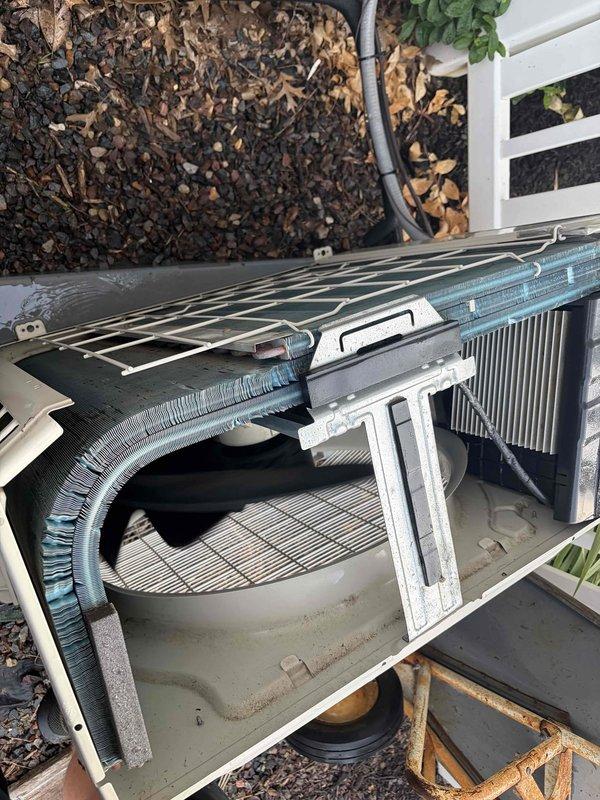 # HVAC Service - No Cool U10

Responded to no cooling complaint on Daikin system with unit located in attic and condenser at ground level. Upon arrival, checked thermostat error history which displayed fault codes B3 and 14, indicating blower motor operational issues and high pressure faults in the air conditioning system. Inspected outdoor condensing unit and removed access panel to examine internal components. Found condenser coils showing dust accumulation and discoloration, with fan assembly accessible for evaluation. Verified error codes correlated with high pressure condition likely caused by restricted airflow through dirty condenser coils. System required cleaning and further diagnostics to restore proper cooling operation.