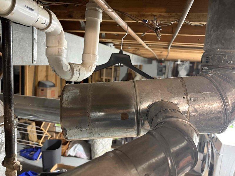 Responded to no-cool call for 11-year-old Rheem system with reported loud noises from outdoor unit. Upon arrival, contacted customer per request and performed diagnostic inspection of outdoor condenser unit to identify source of noise from either fan motor or compressor assembly. Inspected indoor air handler, ductwork connections, and refrigerant lines in basement mechanical area for related issues. Documented system condition with photos showing ductwork installation and basement HVAC infrastructure. Determined cause of operational concern and provided customer with findings and repair recommendations to restore proper system function.