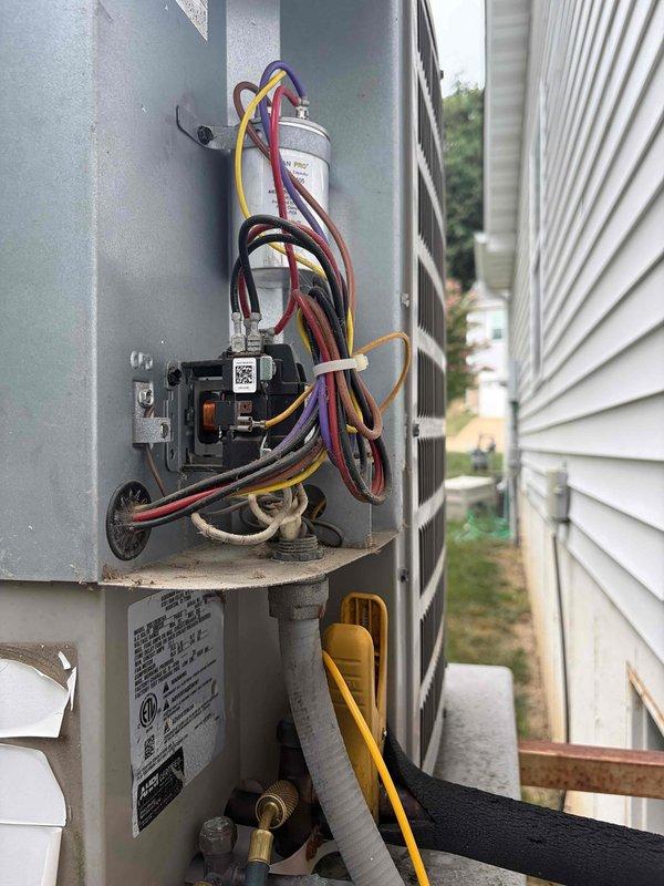 Responded to no cooling complaint on 10+ year old elevated side-mounted condensing unit. Upon arrival, performed system diagnostic and found outdoor unit not operating while indoor air handler fan continued to run as instructed. Inspected outdoor electrical disconnect, capacitor, and associated wiring connections. Evaluated refrigerant line set condition and verified proper insulation coverage. Assessed indoor air handler installation including ductwork connections and cabinet integrity. Documented equipment condition with photos of both indoor and outdoor components for service records.