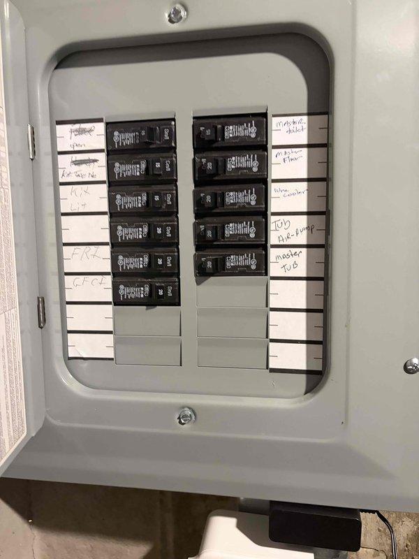 Completed comprehensive whole-home electrical inspection as part of Elite preventive maintenance agreement. Thoroughly examined main electrical panel, documenting breaker configuration, circuit labeling, wire connections, and overall system condition. Panel inspection revealed properly organized circuit breakers with handwritten identification labels, adequate wire management at service entry points, and functional bus bar connections. Photographed panel interior showing multiple circuit breakers, surge protection device, and color-coded wiring including black, white, yellow, brown, and copper conductors entering through conduits. Noted minor dust and debris accumulation at panel base requiring routine cleaning. All breakers appeared operational with visible amperage ratings. Panel enclosure showed good overall condition with no signs of rust, damage, or deterioration to mounting hardware or interior components.