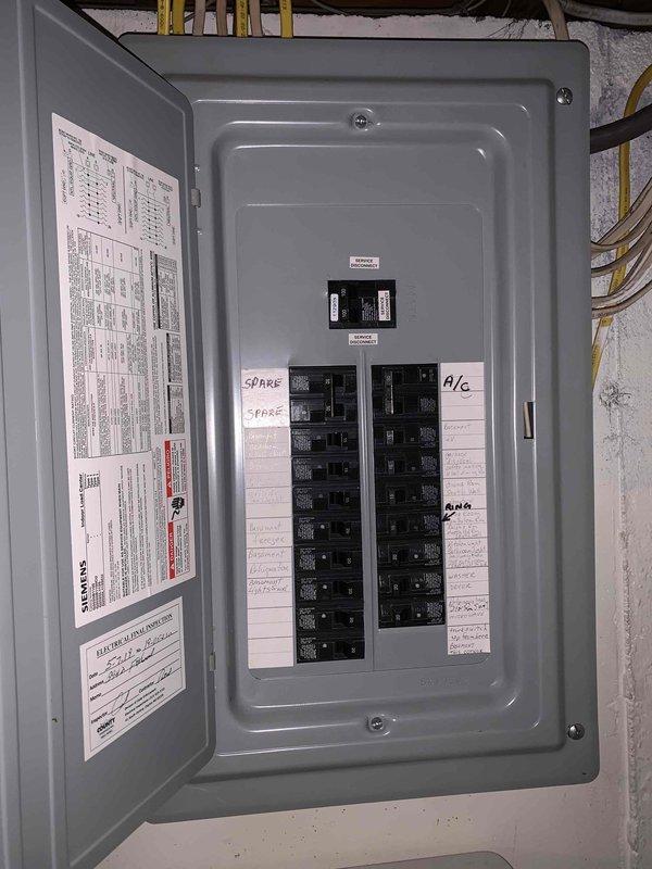 Conducted electrical estimate for Kohler generator installation. Performed site assessment and measured installation area using laser distance measuring equipment, documenting existing electrical panel configuration and available breaker spaces for generator integration. Photographed current electrical distribution panel showing circuit layout and spare capacity for proper load calculation and transfer switch planning.