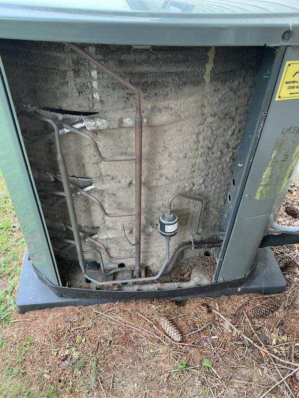 Responded to no cooling complaint on 11-year-old Trane system. Upon inspection, found outdoor unit's condenser coil heavily impacted with dust, dirt, and fibrous debris accumulation, severely restricting airflow and reducing heat exchange efficiency. Cleaned condenser coil thoroughly, removed debris buildup from unit interior, and verified indoor air handler grille condition. System airflow restored to proper operation, cooling function confirmed operational upon completion.