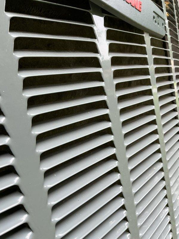 Responded to no cooling complaint on 11-year-old Trane system. Upon inspection, found outdoor unit's condenser coil heavily impacted with dust, dirt, and fibrous debris accumulation, severely restricting airflow and reducing heat exchange efficiency. Cleaned condenser coil thoroughly, removed debris buildup from unit interior, and verified indoor air handler grille condition. System airflow restored to proper operation, cooling function confirmed operational upon completion.
