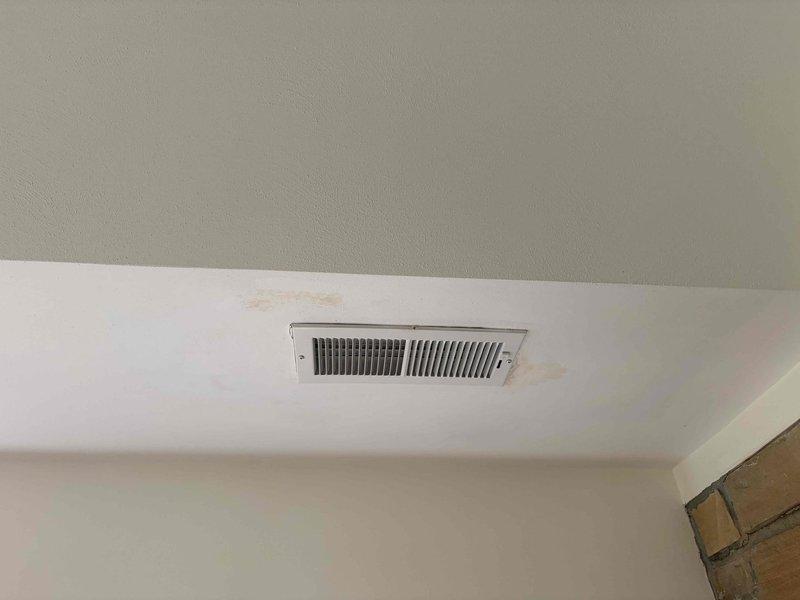 Responded to service call for reported humidifier leak in upstairs closet. Upon inspection, identified active water leakage from humidifier supply line connections causing visible ceiling staining and discoloration in adjacent areas. Discovered corroded PVC pipe joints with rust-colored staining at multiple connection points beneath the humidifier unit, indicating prolonged moisture exposure and deteriorated seals. Documented water damage evidence on ceiling surfaces near HVAC register and compromised plumbing connections. Provided customer with repair recommendations and photographed affected areas for documentation purposes.