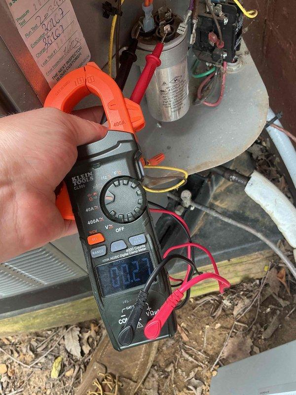 Responded to no cooling complaint on 9-year-old AC system. Upon arrival, confirmed no cold air from vents and condenser fan motor not operating. Initial inspection revealed blown fuses; replaced fuses and verified fan motor operation and cooling restored. Customer reported system failure recurred same evening with complete loss of power to outdoor unit. 

Returned for diagnostic evaluation and performed comprehensive electrical testing. Used clamp meter to measure amperage draw on compressor and fan motor circuits. Readings indicated compressor drawing 84.2 amps, significantly above normal operating range. Connected manifold gauges to measure system pressures and temperatures. Suction pressure reading 64 PSI, discharge pressure 79.8 PSI, with suction line temperature 40.8°F and discharge line temperature 89.3°F. Subcooling measured 10.6°F and superheat 35.6°F, confirming abnormal operating conditions.

Testing revealed failed run capacitor causing excessive amperage draw on compressor,