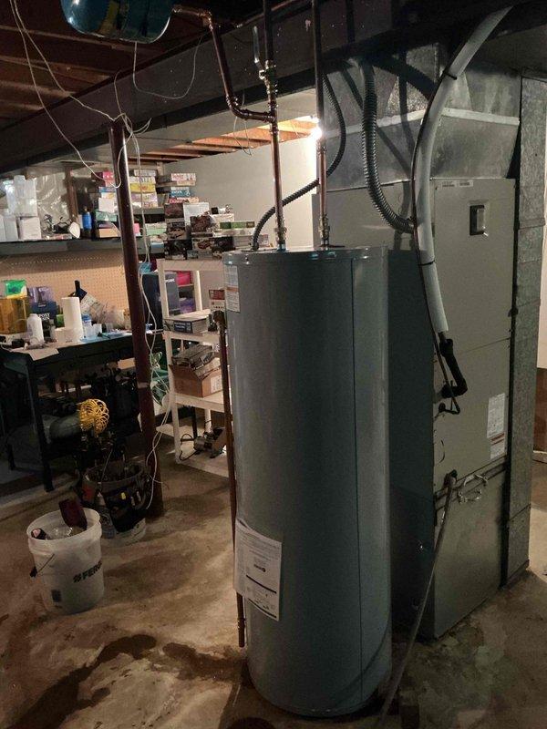 Installed a 50-gallon electric tall water heater in basement utility area with copper piping connections and proper venting configuration. Added a 3/4" pressure reducing valve to the incoming water line to protect the system from excessive pressure, and installed a 3/4" ProPress ball valve for water supply isolation and future serviceability. All connections were completed using ProPress fittings for secure, reliable joints, and the unit was positioned for optimal access alongside existing HVAC equipment.
