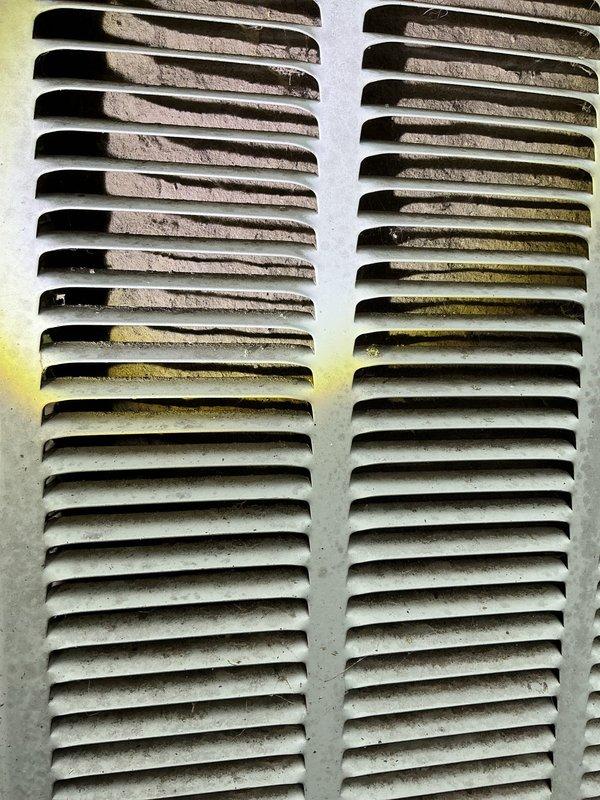 Responded to no cooling complaint on 10+ year old residential HVAC system. Upon arrival, found exterior ventilation grilles heavily contaminated with mold, algae, and biological growth, indicating significant airflow restriction and moisture intrusion. Documented extensive weathering and deterioration of exterior components, completed diagnostic evaluation, and contacted property owner with findings and recommendations for system restoration.