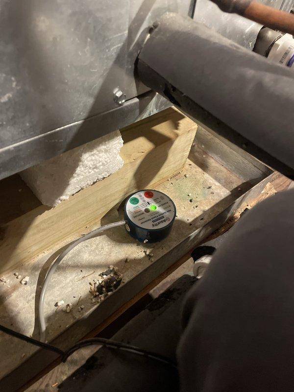 Installed replacement hockey puck wet switch in attic-mounted HVAC system as warranty repair. Verified proper operation with green indicator light illuminated and confirmed unit heating and cooling functions operating normally upon completion.