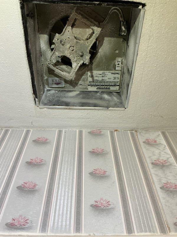 Completed exhaust fan motor replacement in bathroom ventilation system. Removed heavily deteriorated motor unit with significant dust and lint accumulation, installed new replacement motor, and verified proper operation of ceiling-mounted fixture with restored airflow functionality.