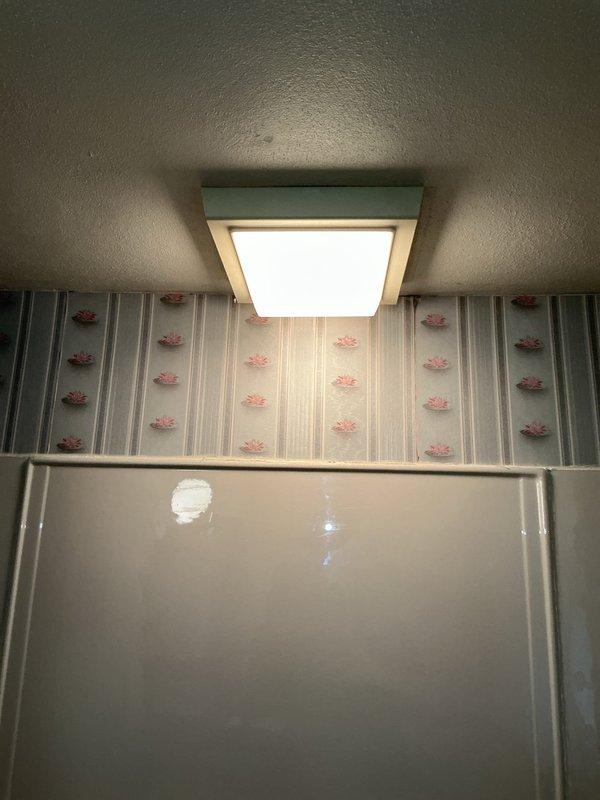 Completed exhaust fan motor replacement in bathroom ventilation system. Removed heavily deteriorated motor unit with significant dust and lint accumulation, installed new replacement motor, and verified proper operation of ceiling-mounted fixture with restored airflow functionality.