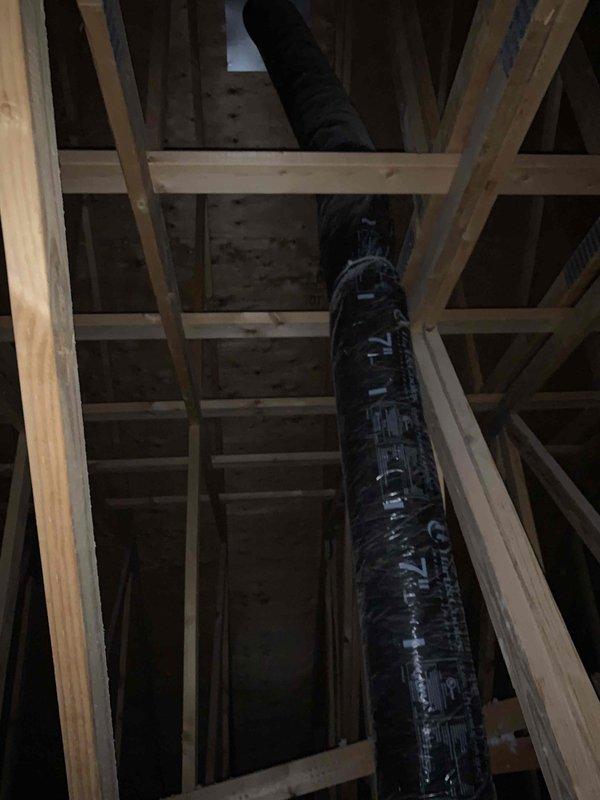 Responded to service call for AC unit not maintaining set temperature on east side system. Upon arrival, performed diagnostic assessment of the affected unit, which is part of a 4-unit system less than 10 years old. Inspected attic ductwork and found black flexible duct installation requiring evaluation. Measured supply air temperature and airflow at ceiling register using digital instruments to assess system performance. Customer had been advised to turn unit off and leave fan running prior to service visit to prevent potential compressor damage.
