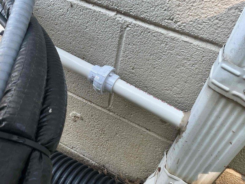 Responded to service call for mini split system leaking down interior wall. Upon inspection, identified improperly pitched condensate drain line on exterior of building causing water backup and overflow into living space. Corrected drain line pitch to ensure proper gravity drainage, verified condensate flow, and confirmed leak resolution with system operational test.