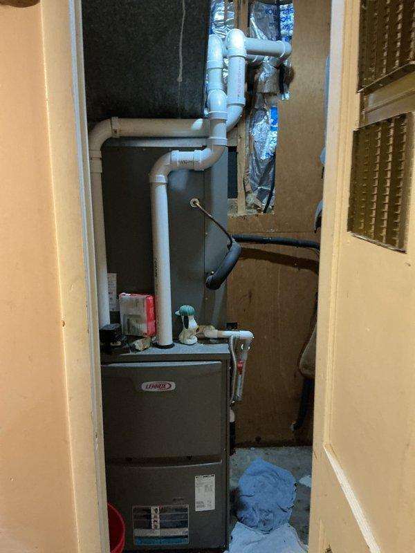 Responded to service call for condensation issues with AC system causing water accumulation in ceiling and vents. Upon inspection, found excessive sweating on both the indoor air handler and outdoor condensing unit. Diagnosed primary issue as blocked condensate drain line preventing proper drainage from the evaporator coil. Cleared obstruction from condensate drain system and verified proper flow through PVC drainage piping. Inspected Lennox furnace and air handler assembly for proper insulation and airflow restrictions. Checked refrigerant levels and confirmed system operating within manufacturer specifications. Verified all ductwork connections were secure and properly sealed to prevent future condensation issues. System tested and operating normally with no further water accumulation observed.