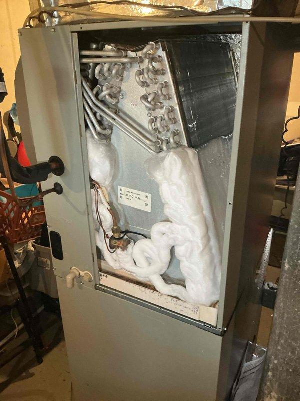Responded to callback for system failure following recent transformer replacement. Upon arrival, found air handler with severe evaporator coil icing and frozen refrigerant lines. Accessed unit cabinet and documented extensive ice buildup throughout interior, indicating restricted airflow or low refrigerant charge. Inspected electrical connections and transformer installation from previous service visit. Identified compromised system operation requiring further diagnosis to determine root cause of icing condition and system malfunction.