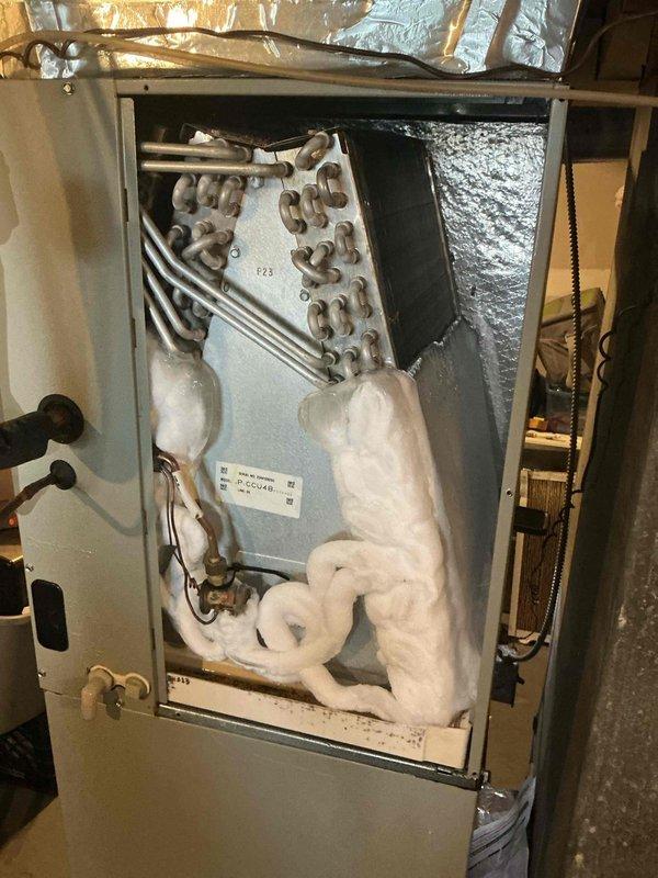 Responded to callback for system failure following recent transformer replacement. Upon arrival, found air handler with severe evaporator coil icing and frozen refrigerant lines. Accessed unit cabinet and documented extensive ice buildup throughout interior, indicating restricted airflow or low refrigerant charge. Inspected electrical connections and transformer installation from previous service visit. Identified compromised system operation requiring further diagnosis to determine root cause of icing condition and system malfunction.