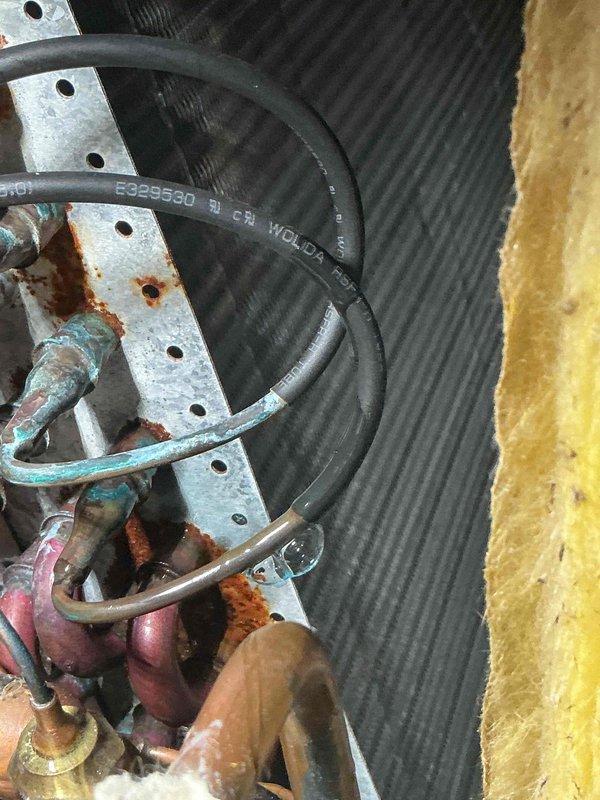 Responded to service call for 13-year-old Lennox A/C system running continuously without adequate cooling, with indoor temperature reaching 81°F despite thermostat set to 72°F. Upon arrival, performed comprehensive system diagnostics using manifold gauges and digital thermometers to assess refrigerant pressures, temperatures, and airflow at supply registers. Inspection revealed significant corrosion on refrigerant line connections, copper tubing, and mounting brackets at the outdoor unit, indicating prolonged moisture exposure and potential refrigerant leak points. Supply air temperature measured at 76.2°F, confirming insufficient cooling capacity. Documented extensive rust on metal components and green patina on copper lines, suggesting system has been operating with compromised refrigerant charge. Provided customer with findings and recommendations for necessary repairs to restore proper cooling function.