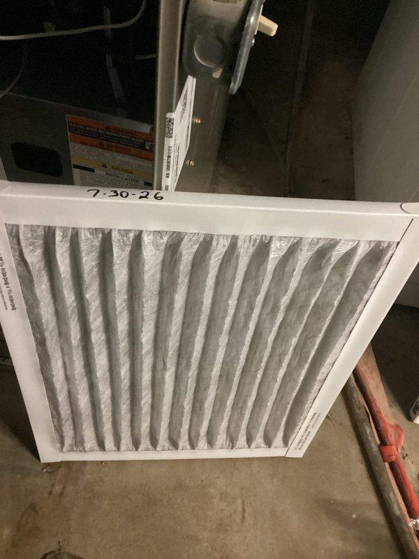 Responded to no-cooling call for 10+ year old residential air conditioning system located in backyard. Upon arrival, confirmed unit was not operating. Connected diagnostic gauges to outdoor condensing unit and performed system evaluation. Inspected indoor air handler and documented condition of air filter, which showed accumulated dust and debris. Completed diagnostic testing to identify cause of system failure and photographed equipment condition for service records.