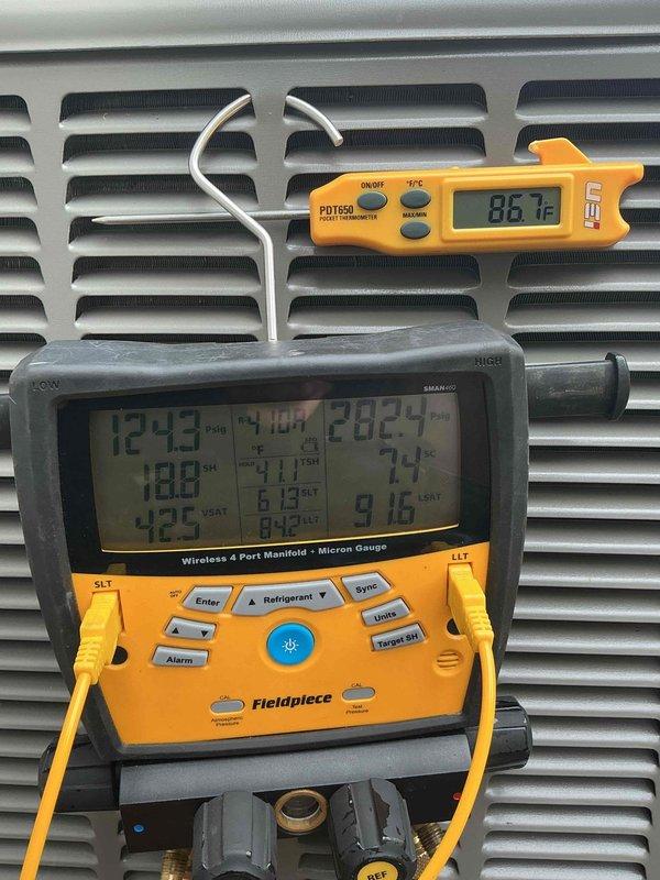 Responded to service call for newly installed upstairs system experiencing power issues with condensate pump. Upon arrival, inspected electrical connections and found wiring concerns at circuit breaker terminal. Verified power supply to pump and tested system operation using manifold gauges and digital thermometer. System readings showed supply temperature of 86.1°F with pressures and temperatures recorded on diagnostic equipment. Addressed electrical connection at breaker point where blue and brown conductors terminate. Documented all measurements and electrical configuration for ongoing callback history on this recent installation.