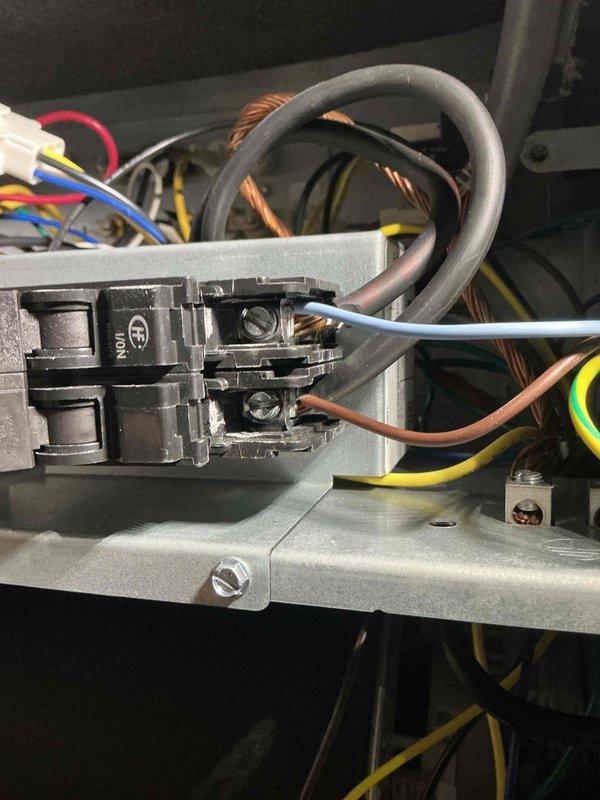 Responded to service call for newly installed upstairs system experiencing power issues with condensate pump. Upon arrival, inspected electrical connections and found wiring concerns at circuit breaker terminal. Verified power supply to pump and tested system operation using manifold gauges and digital thermometer. System readings showed supply temperature of 86.1°F with pressures and temperatures recorded on diagnostic equipment. Addressed electrical connection at breaker point where blue and brown conductors terminate. Documented all measurements and electrical configuration for ongoing callback history on this recent installation.