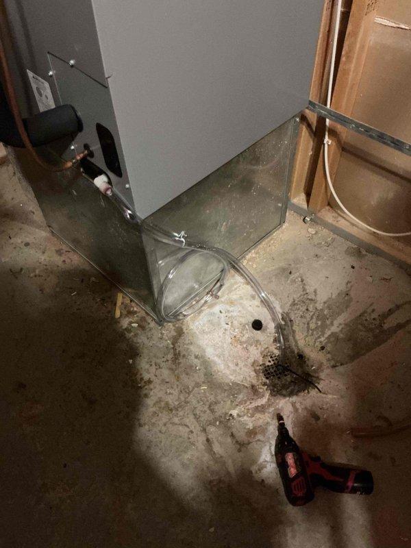 Returned to property to complete condensate drain repair on HVAC system. Installed new 1/2" drain tube to replace defective drainage line, routing clear tubing from equipment to floor drain in basement mechanical room. Verified proper drainage flow and system operation upon completion.