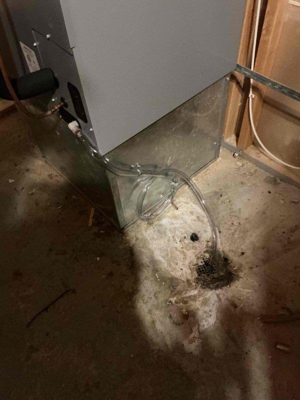 Returned to property to complete condensate drain repair on HVAC system. Installed new 1/2" drain tube to replace defective drainage line, routing clear tubing from equipment to floor drain in basement mechanical room. Verified proper drainage flow and system operation upon completion.