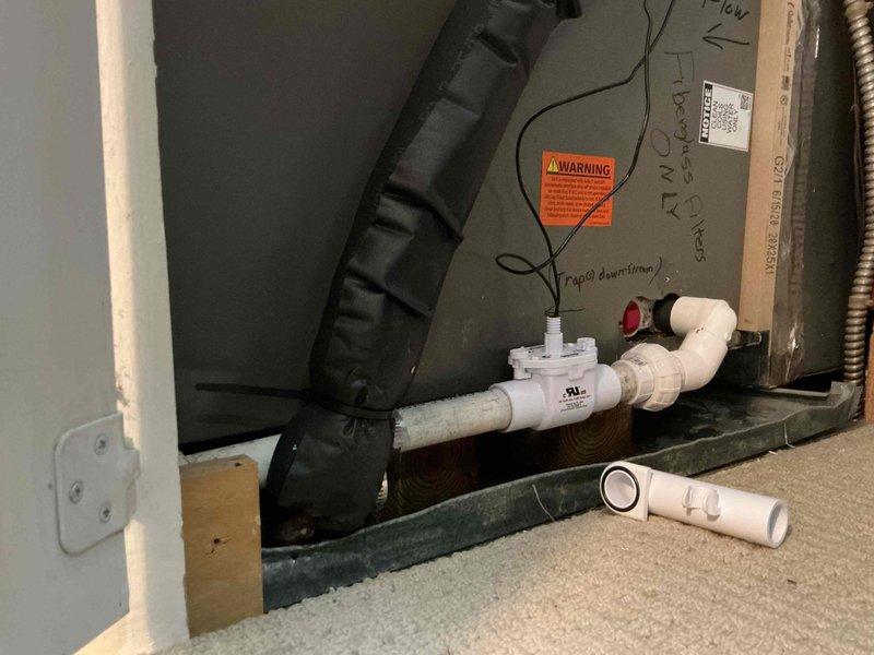 Completed callback to address ongoing condensate drainage issue where unit was rapidly filling with water. Removed existing trap configuration and repiped condensate drain system, installing inline float safety switch to match original setup and prevent water backup. Verified proper drainage flow and tested float switch operation to ensure system protection.