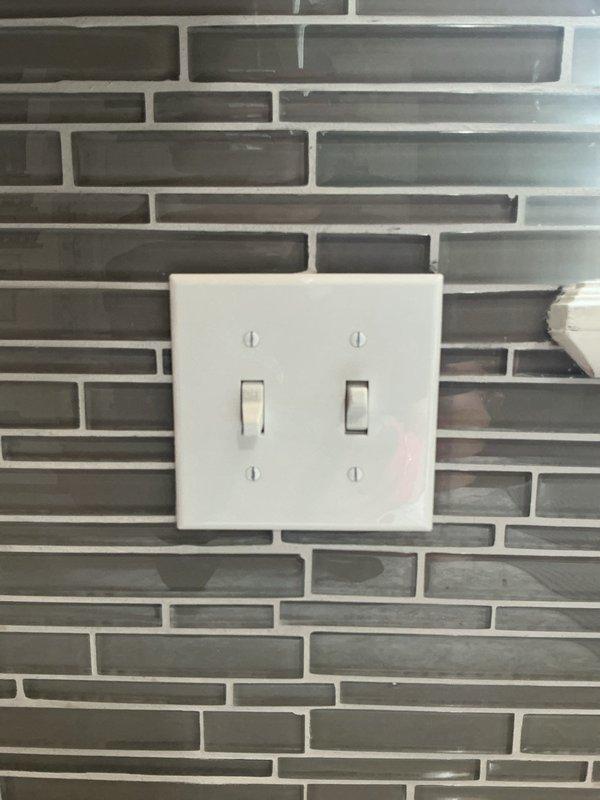 Responded to service call for non-functional garbage disposal switch. Inspected double-gang switch plate at kitchen backsplash and verified electrical panel circuit breaker configuration. Troubleshot 12-5 switch circuit, identified issue, and restored proper operation to garbage disposal control switch.