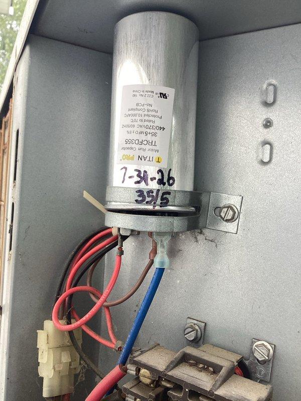 Responded to no cooling complaint on 10+ year old residential AC unit maintaining 83°F with outdoor fan running. Upon inspection, diagnosed failed dual run capacitor (TITAN THORP355 35/5 MFD rated 440/370V) in outdoor condensing unit. Replaced defective capacitor with new component, restored proper compressor and condenser fan motor operation, and verified system cooling performance.