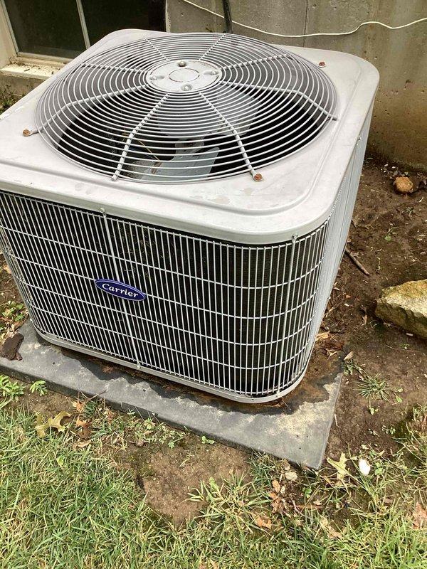 Responded to no cooling complaint with indoor temperature at 83 degrees. Upon arrival, inspected Carrier condensing unit located on side of home, confirmed unit over 10 years old based on equipment data plate. Performed diagnostic evaluation of system components, documented equipment model and serial number information, and captured photographic evidence of outdoor unit condition and manufacturer specifications for service records.