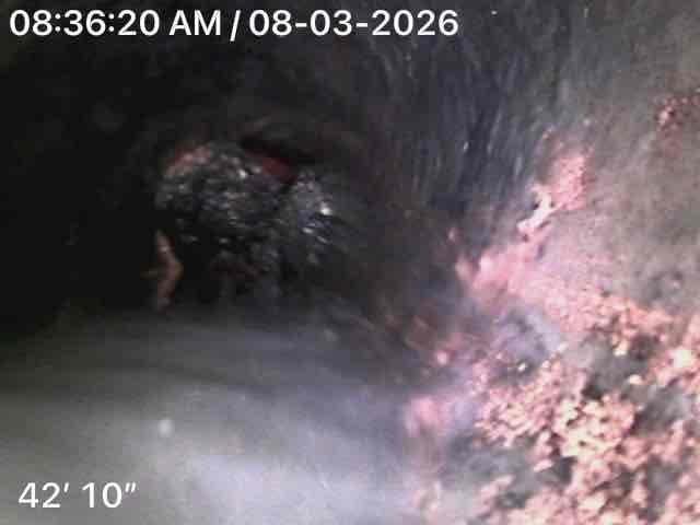 Performed camera inspection of sewer lateral line in response to basement flooding. Inspection revealed significant deterioration of pipe interior at approximately 42'10", including exposed substrate material and debris accumulation on pipe floor. Completed all required county paperwork on-site for sewer lateral program documentation and submission.