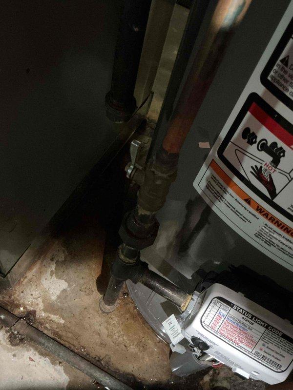 Responded to reported water leak under gas water heater in basement. Completed installation of replacement tanked gas water heater with new expansion tank mounted on top. Connected copper supply lines, installed proper venting with flexible ductwork, and verified all connections for leaks. Unit tested and operational upon completion.