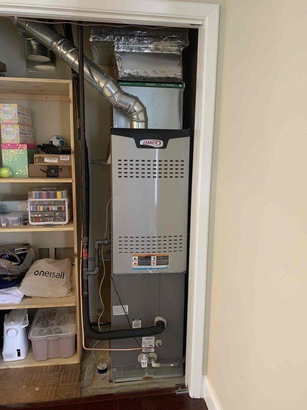 Replaced defective evaporator coil under warranty on residential Lennox furnace system located in utility closet. Uninstalled existing furnace unit to access and remove failed coil, installed new evaporator coil (S/N T22A04858), reassembled system, and verified proper heating and cooling operation upon completion.