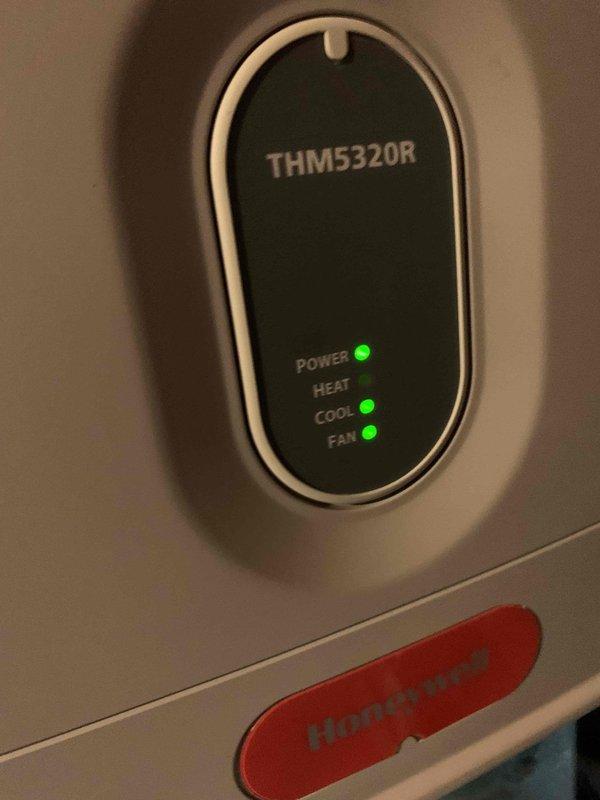 Responded to no-cool call for 10+ year old ground-level unit. Upon arrival, found upstairs unit not powering on. Inspected Honeywell THM5320R thermostat and confirmed no power indication to system. Traced electrical issue to air handler located in basement and verified unit was not receiving call for cooling. Diagnosed and resolved power supply issue, restoring operation to system. Unit tested successfully with all functions operational upon departure.