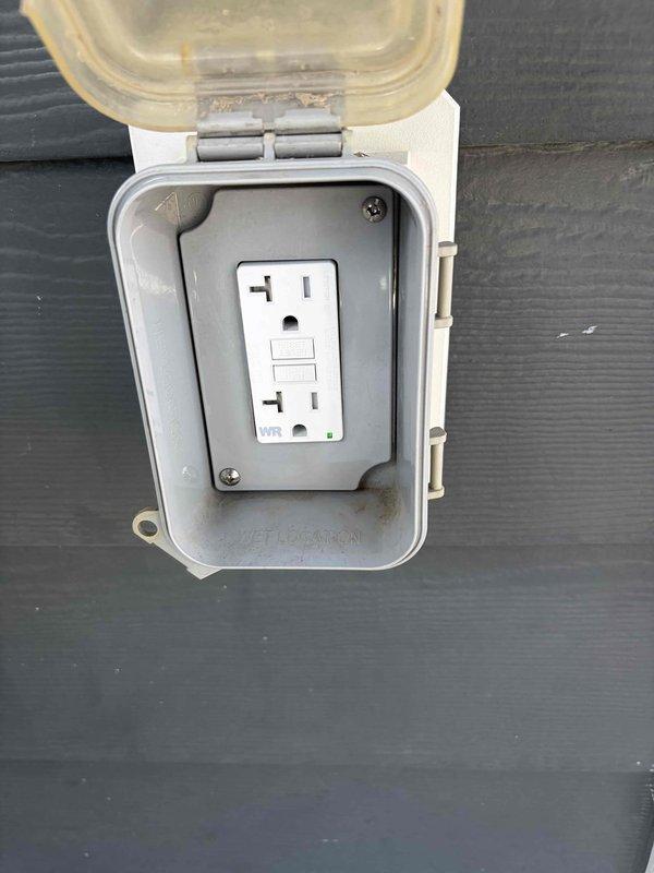 Completed installation of dedicated circuit with GFCI protection, including exterior weatherproof outlet box with wet location rating mounted on building siding and interior duplex receptacles. All outlets tested and verified operational per code requirements.